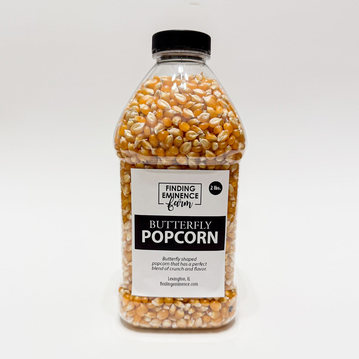 Bottle of butterfly popcorn with black screw top lid. 